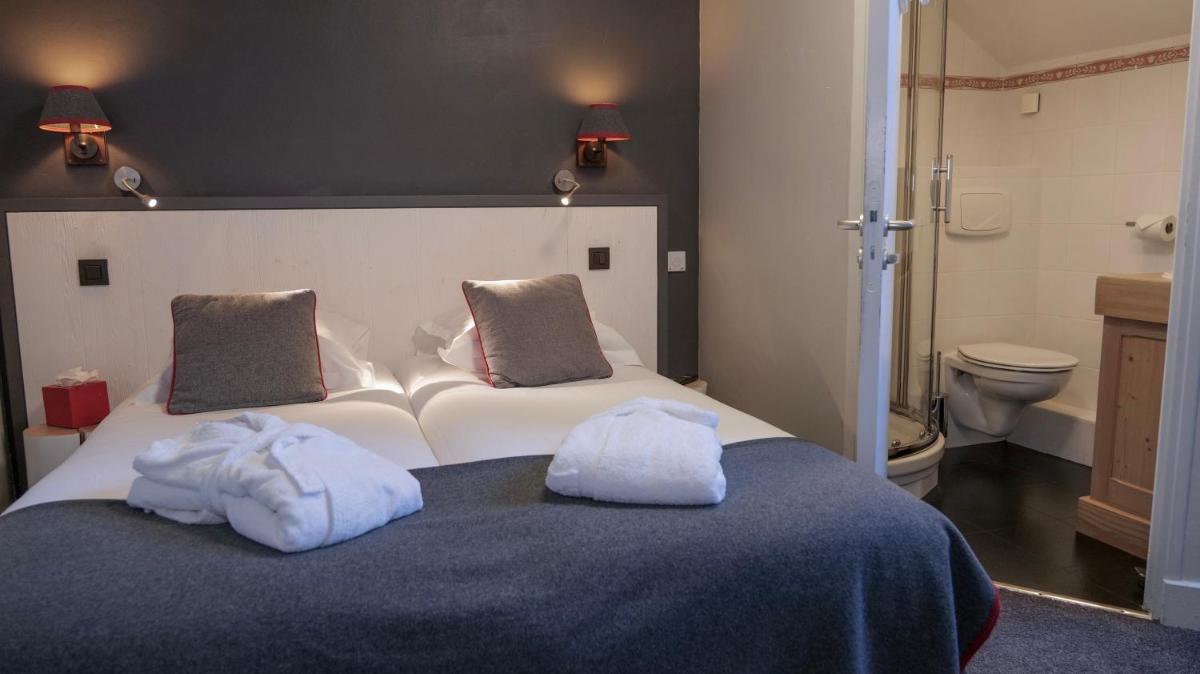 Un ou plusieurs lits dans un hébergement de l'établissement Le Faucigny - Hotel de Charme & SPA