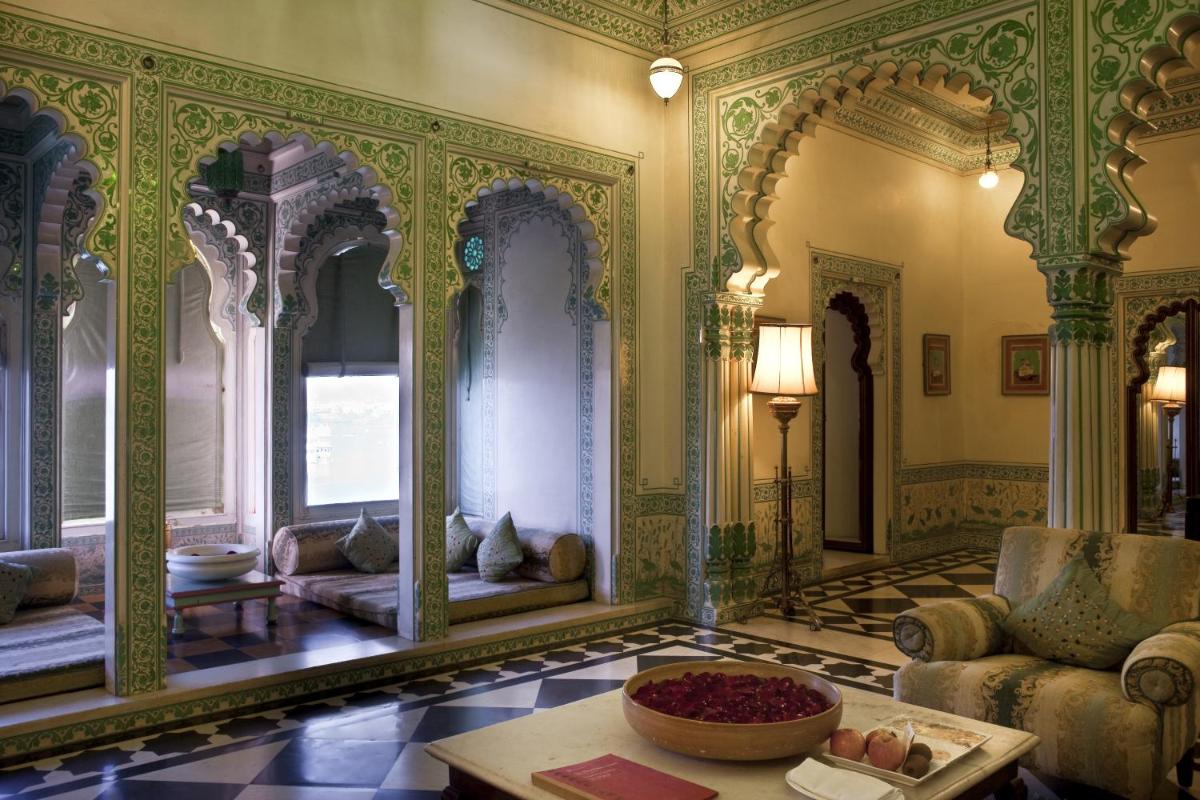 a living room with a couch and a table at Shiv Niwas Palace by HRH Group of Hotels in Udaipur