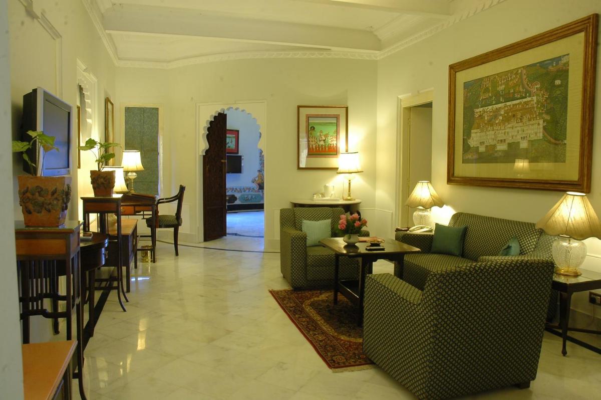 a living room with couches and a dining room at Shiv Niwas Palace by HRH Group of Hotels in Udaipur