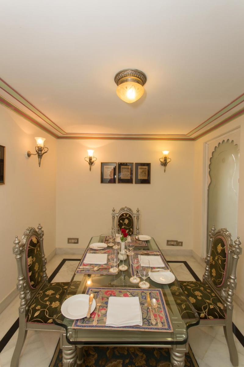 a dining room with a table and two chairs at Shiv Niwas Palace by HRH Group of Hotels in Udaipur