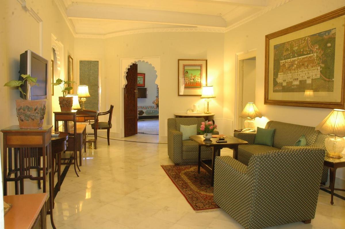 a living room with couches and chairs and tables at Shiv Niwas Palace by HRH Group of Hotels in Udaipur