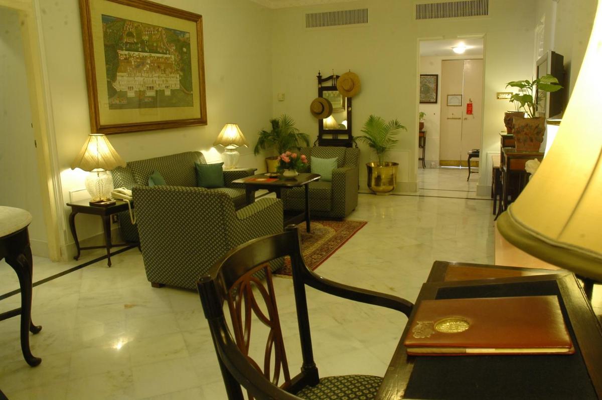 a living room with couches and tables and chairs at Shiv Niwas Palace by HRH Group of Hotels in Udaipur
