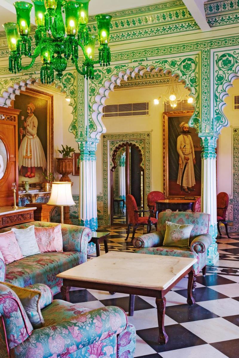a living room with couches and a coffee table at Shiv Niwas Palace by HRH Group of Hotels in Udaipur