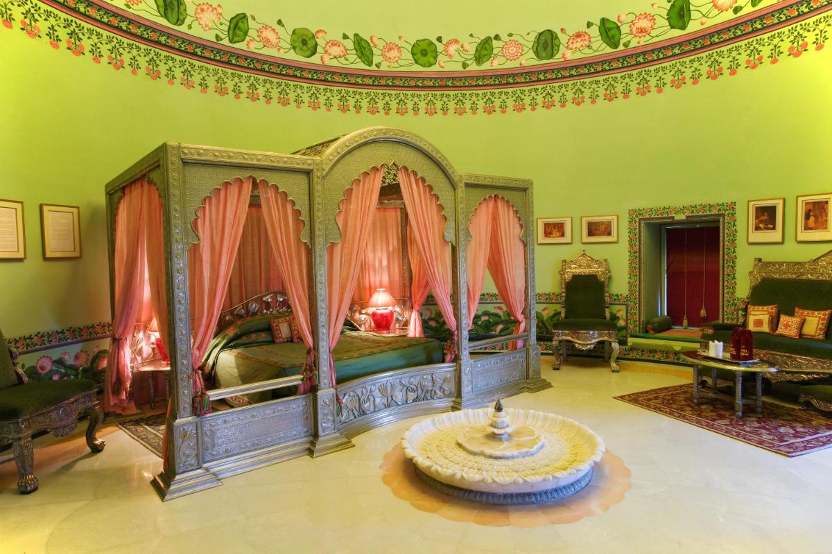 a bedroom with a canopy bed in a room at Shiv Niwas Palace by HRH Group of Hotels in Udaipur