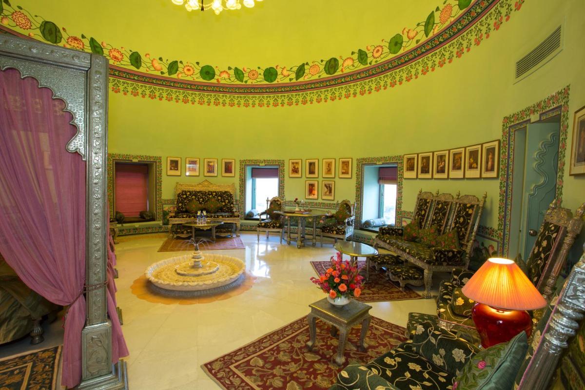 a large living room with a large ceiling at Shiv Niwas Palace by HRH Group of Hotels in Udaipur