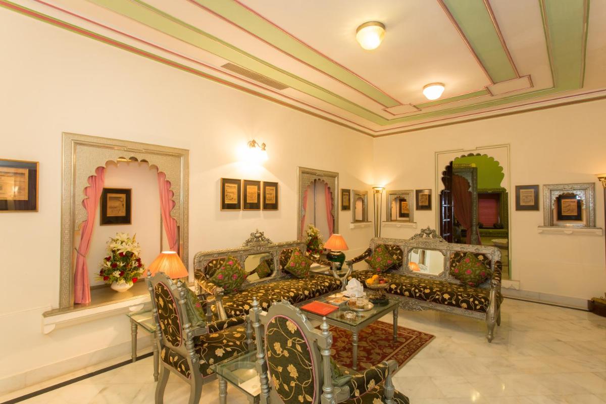 a living room with couches and a table at Shiv Niwas Palace by HRH Group of Hotels in Udaipur