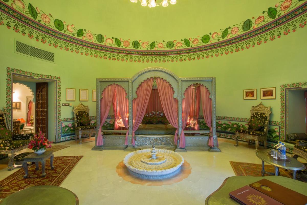 a living room with a couch and a table at Shiv Niwas Palace by HRH Group of Hotels in Udaipur