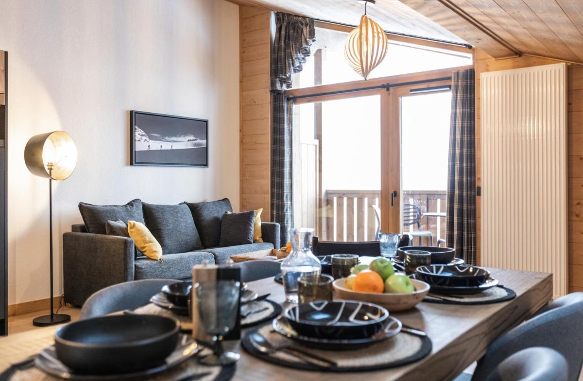un salon avec une table avec de la nourriture dessus dans l'établissement TERRESENS - Le Snoroc, à Aime La Plagne