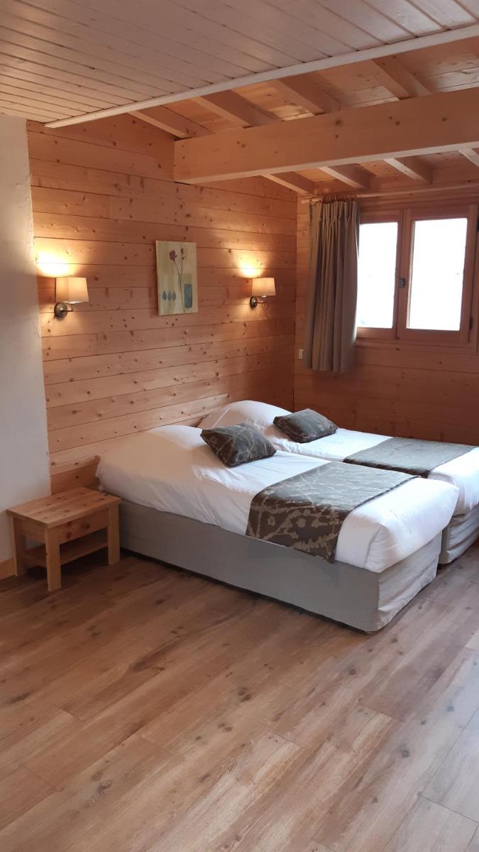 Un ou plusieurs lits dans un hébergement de l'établissement Logis Hotel & Spa Beau-Site