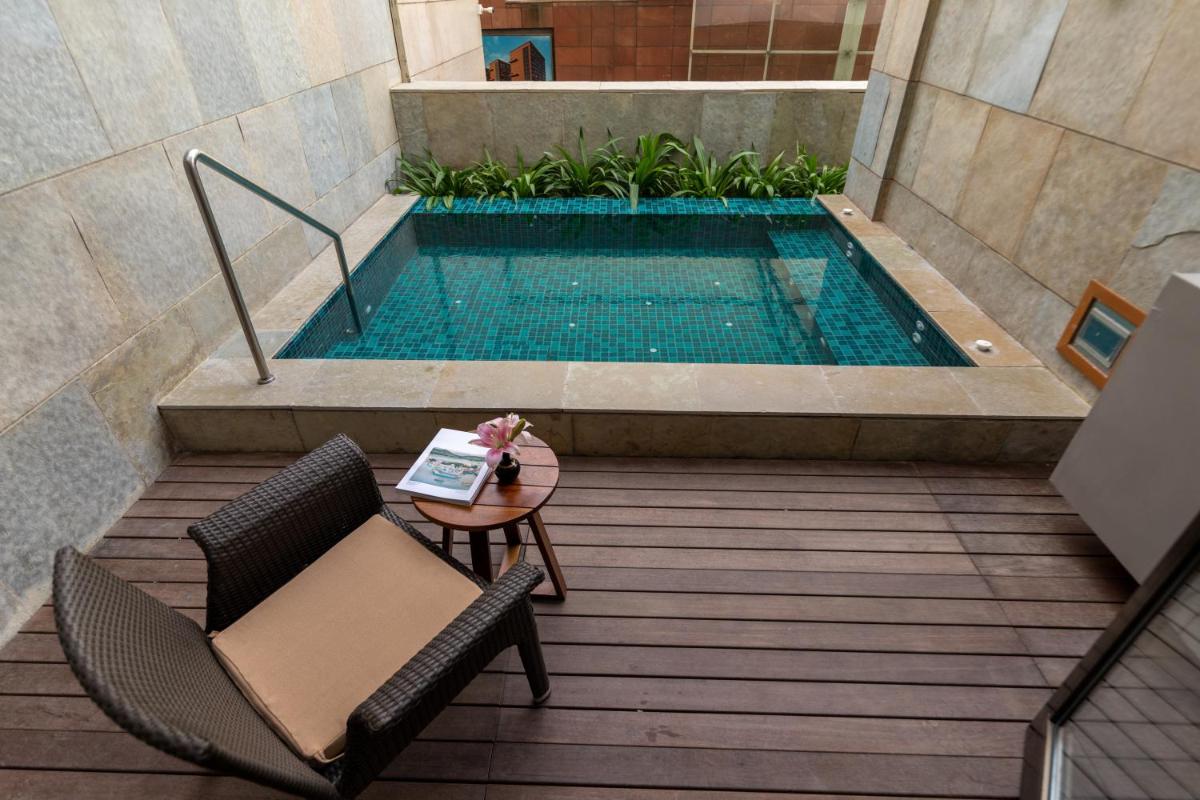 a patio with a table and chairs and a pool at Taj City Centre New Town, Kolkata in Kolkata a patio with a table and chairs and a pool at Taj City Centre New Town, Kolkata in Kolkata