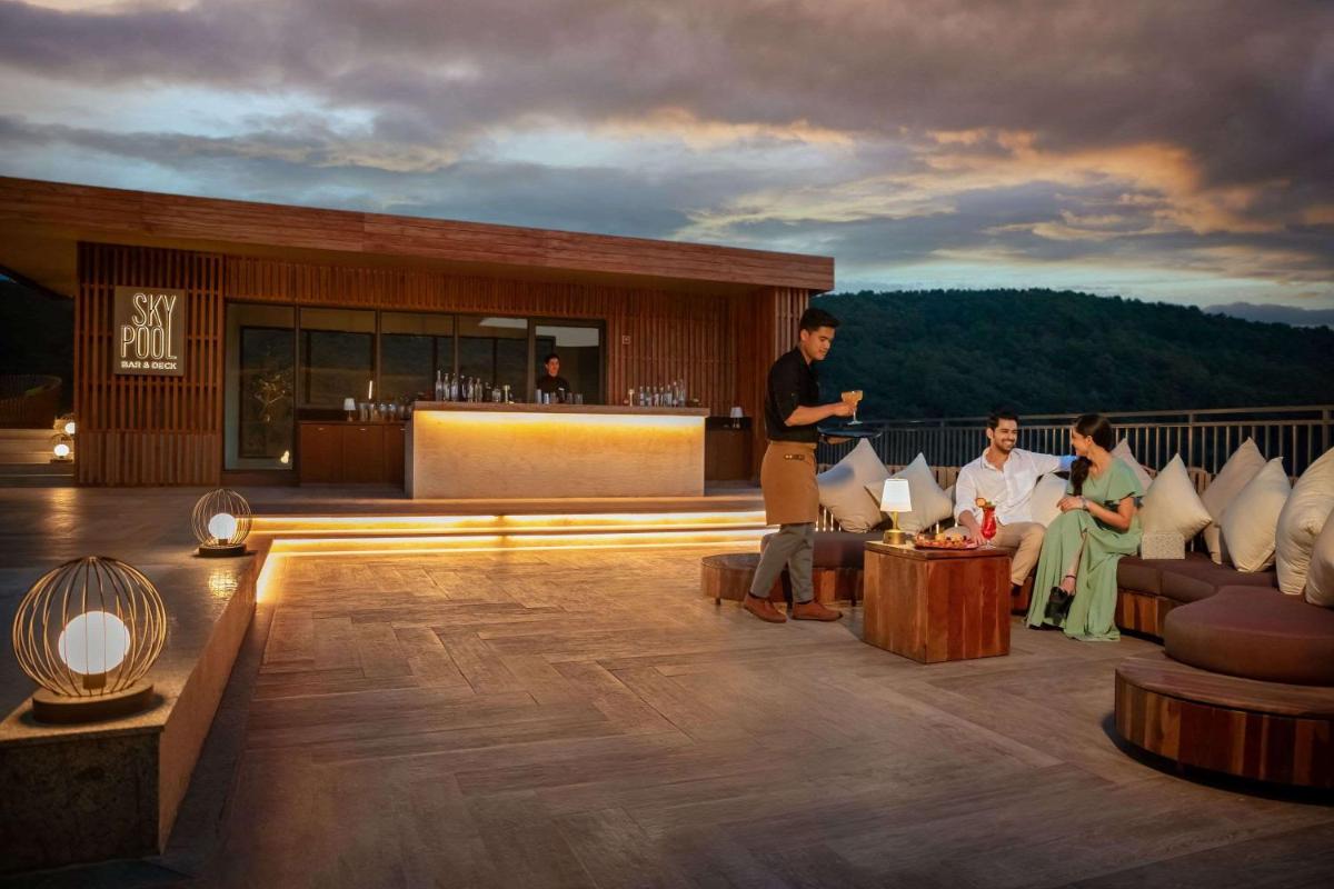 a group of people sitting on the deck of a resort at Hyatt Regency Dehradun Resort and Spa in Dehradun