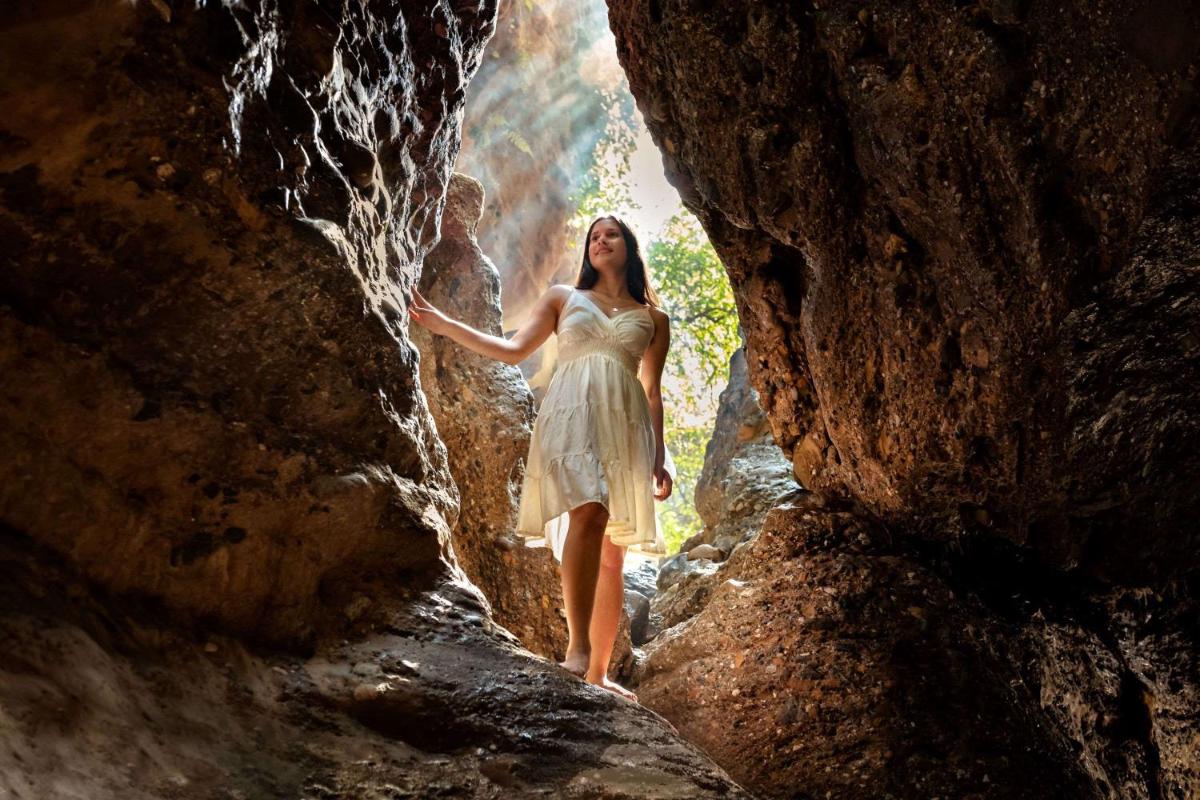 a woman in a dress walking through a cave at Hyatt Regency Dehradun Resort and Spa in Dehradun
