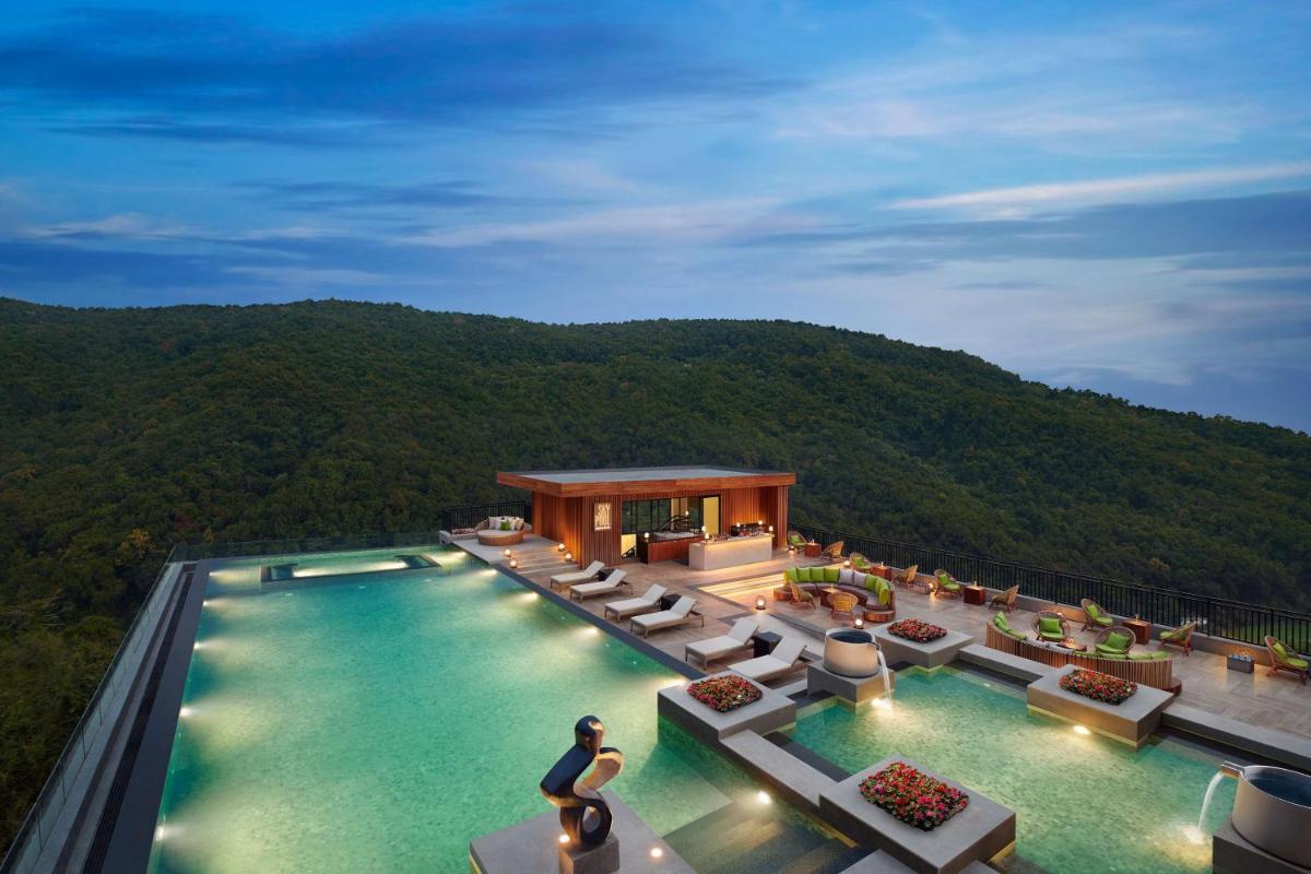 a view of a swimming pool on a resort at Hyatt Regency Dehradun Resort and Spa in Dehradun