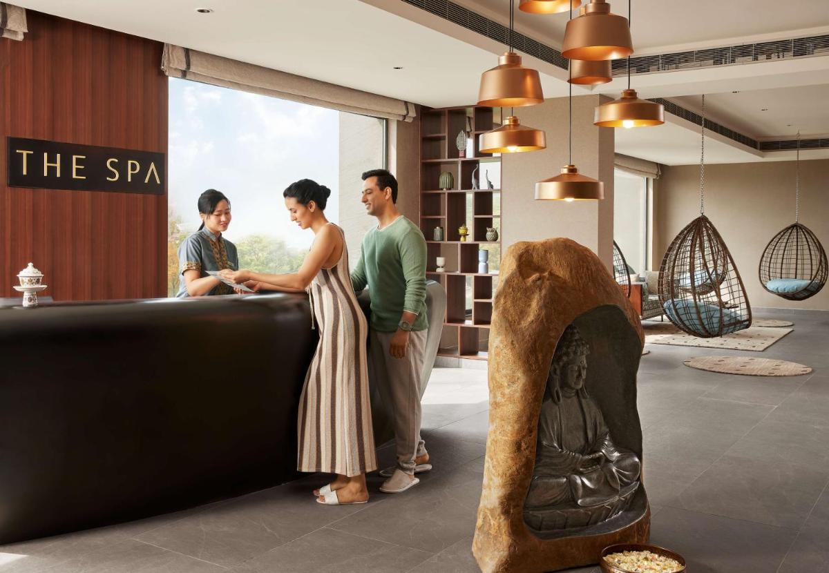 a group of three people standing in a room at Hyatt Regency Dehradun Resort and Spa in Dehradun