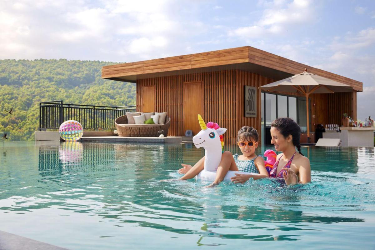 a woman and a child in a swimming pool at Hyatt Regency Dehradun Resort and Spa in Dehradun