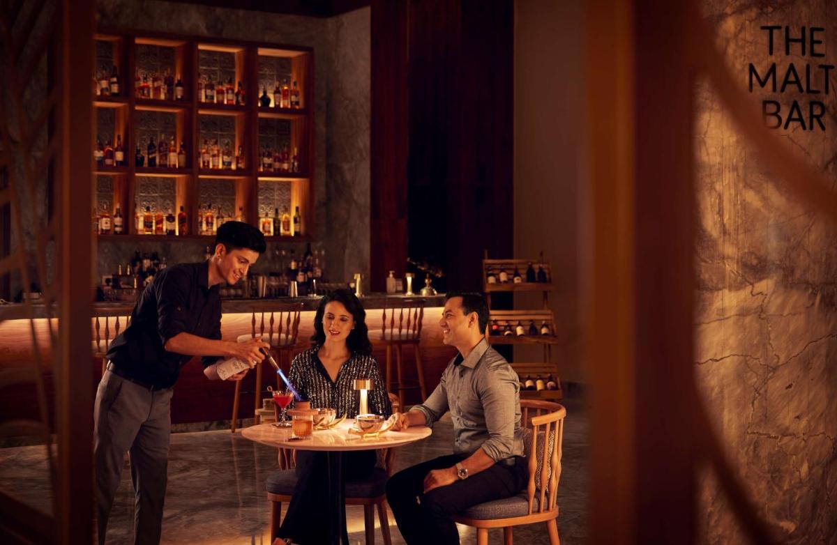 a group of people sitting at a table in a restaurant at Hyatt Regency Dehradun Resort and Spa in Dehradun