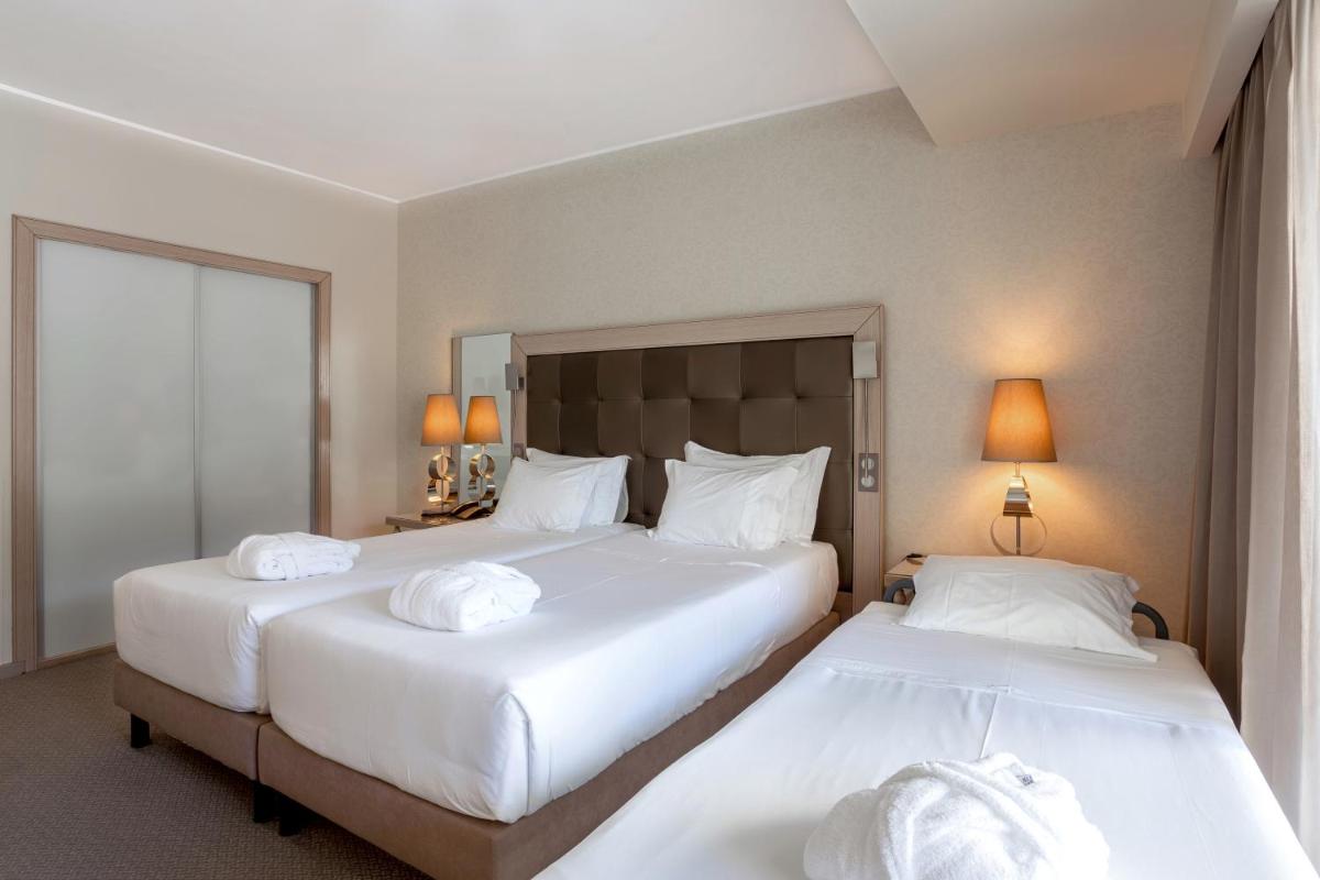 Uma cama ou camas num quarto em Hotel Porta do Sol Conference & SPA