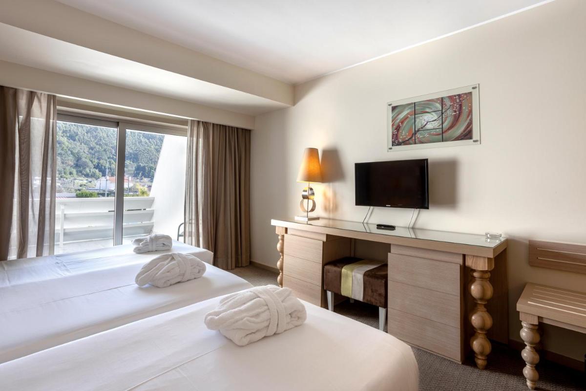 Uma cama ou camas num quarto em Hotel Porta do Sol Conference & SPA