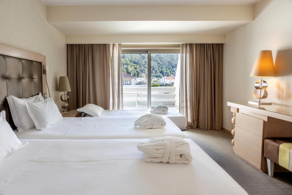 Uma cama ou camas num quarto em Hotel Porta do Sol Conference & SPA