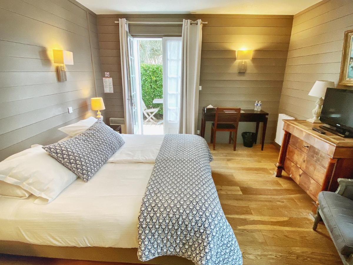 Un ou plusieurs lits dans un hébergement de l'établissement Hotel L'Océan
