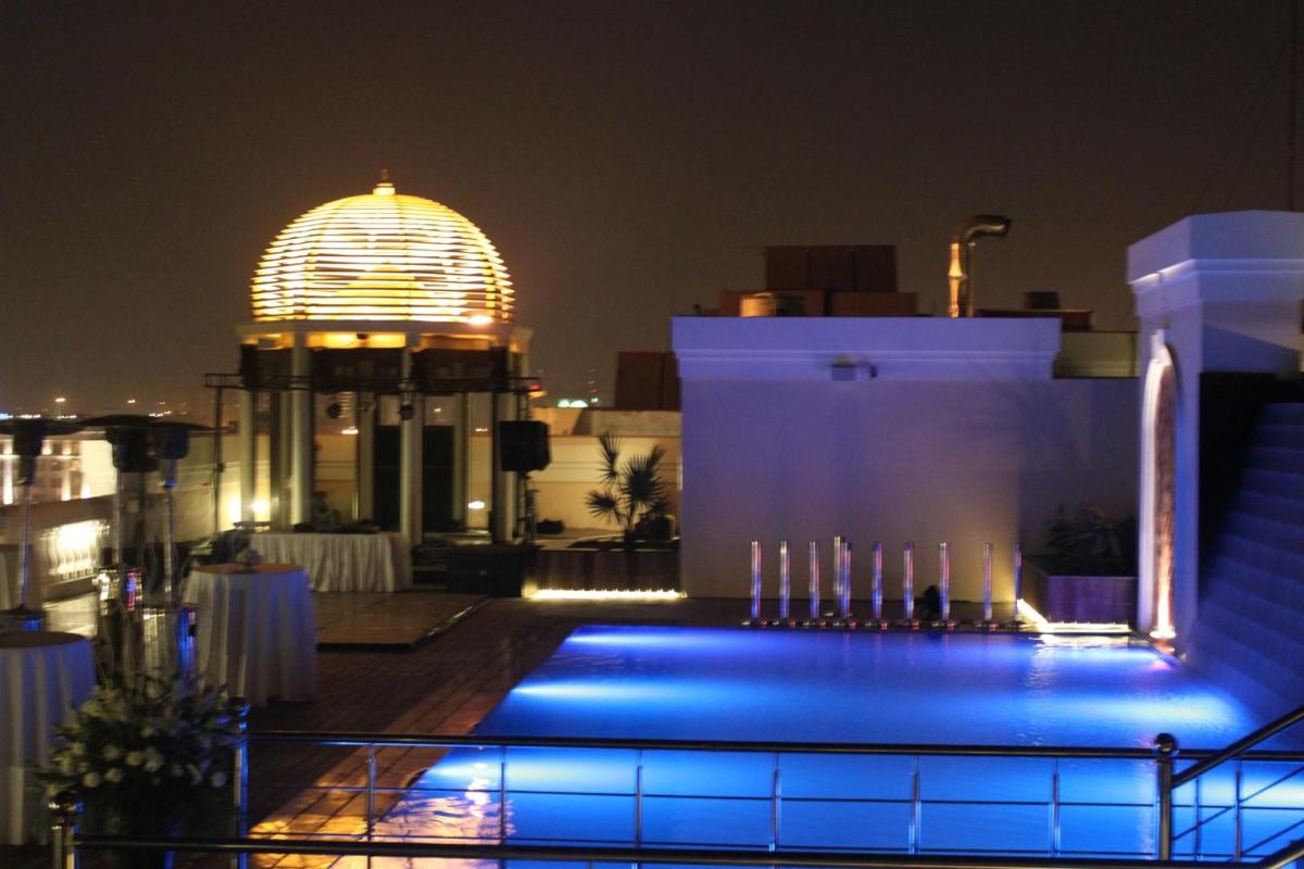 a building with a lit up dome at night at The Pllazio Hotel in Gurgaon