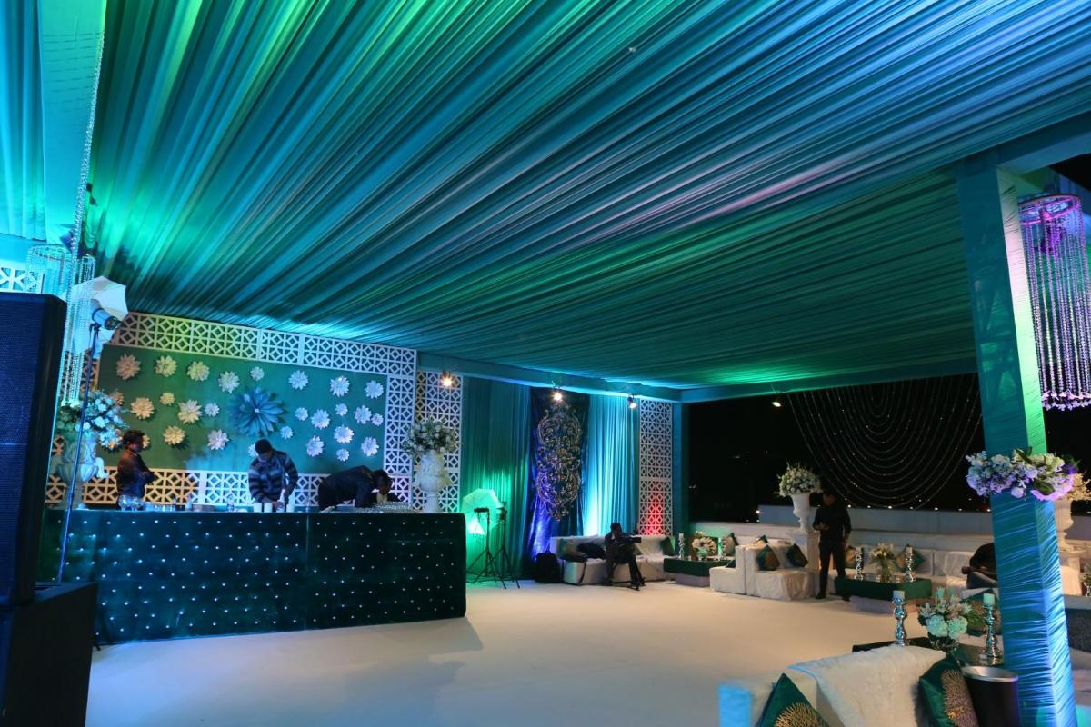 a room with a blue ceiling and a stage at The Pllazio Hotel in Gurgaon