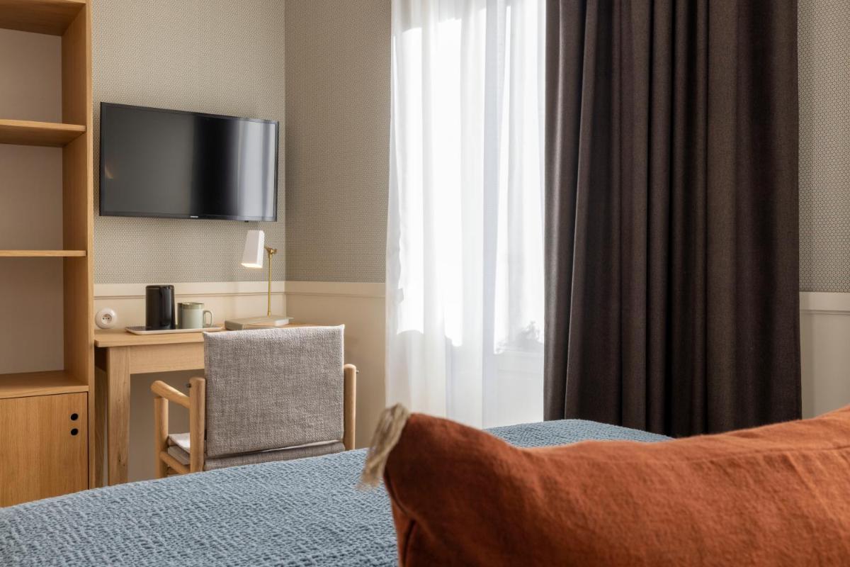 Un ou plusieurs lits dans un hébergement de l'établissement Le Petit Oberkampf Hotel & Spa