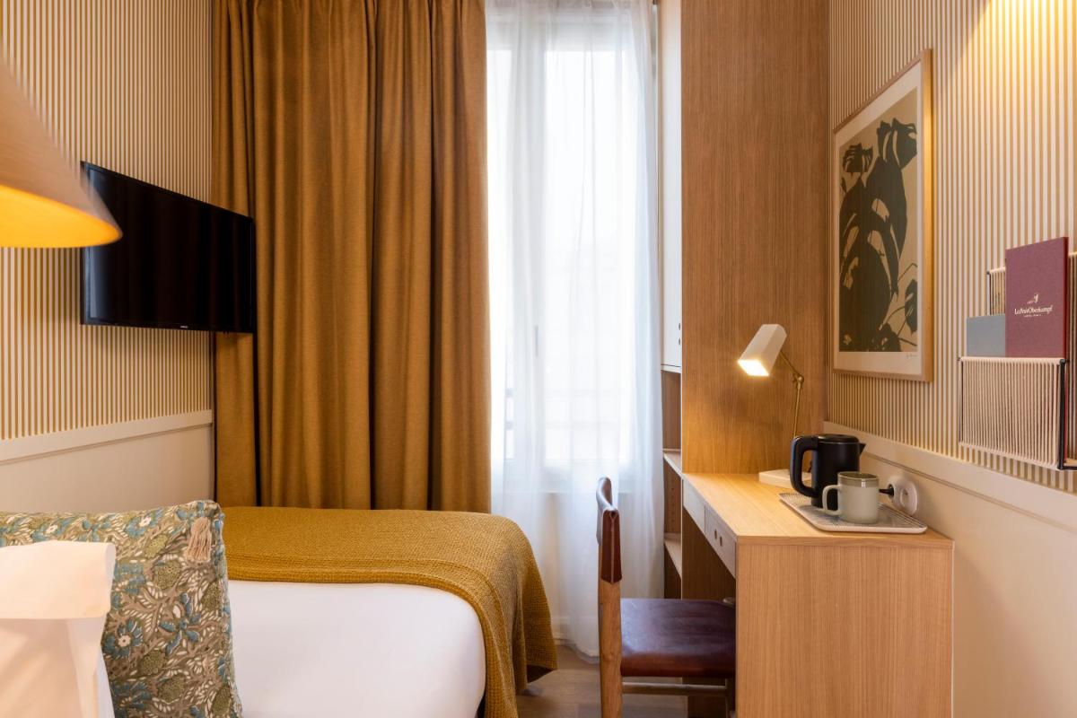 Télévision ou salle de divertissement dans l'établissement Le Petit Oberkampf Hotel & Spa