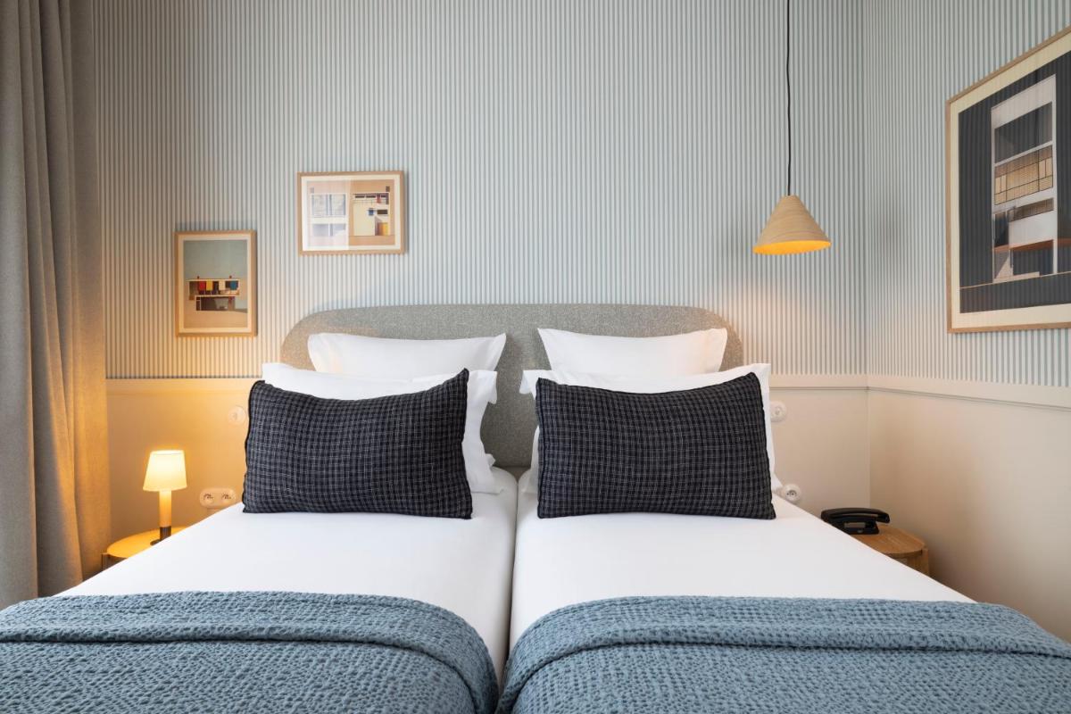 Un ou plusieurs lits dans un hébergement de l'établissement Le Petit Oberkampf Hotel & Spa