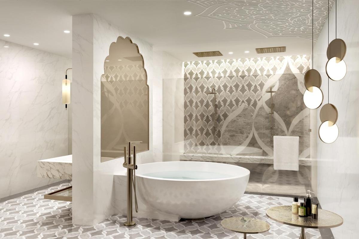 a white bathroom with a tub and a shower at Taj Amer, Jaipur in Jaipur