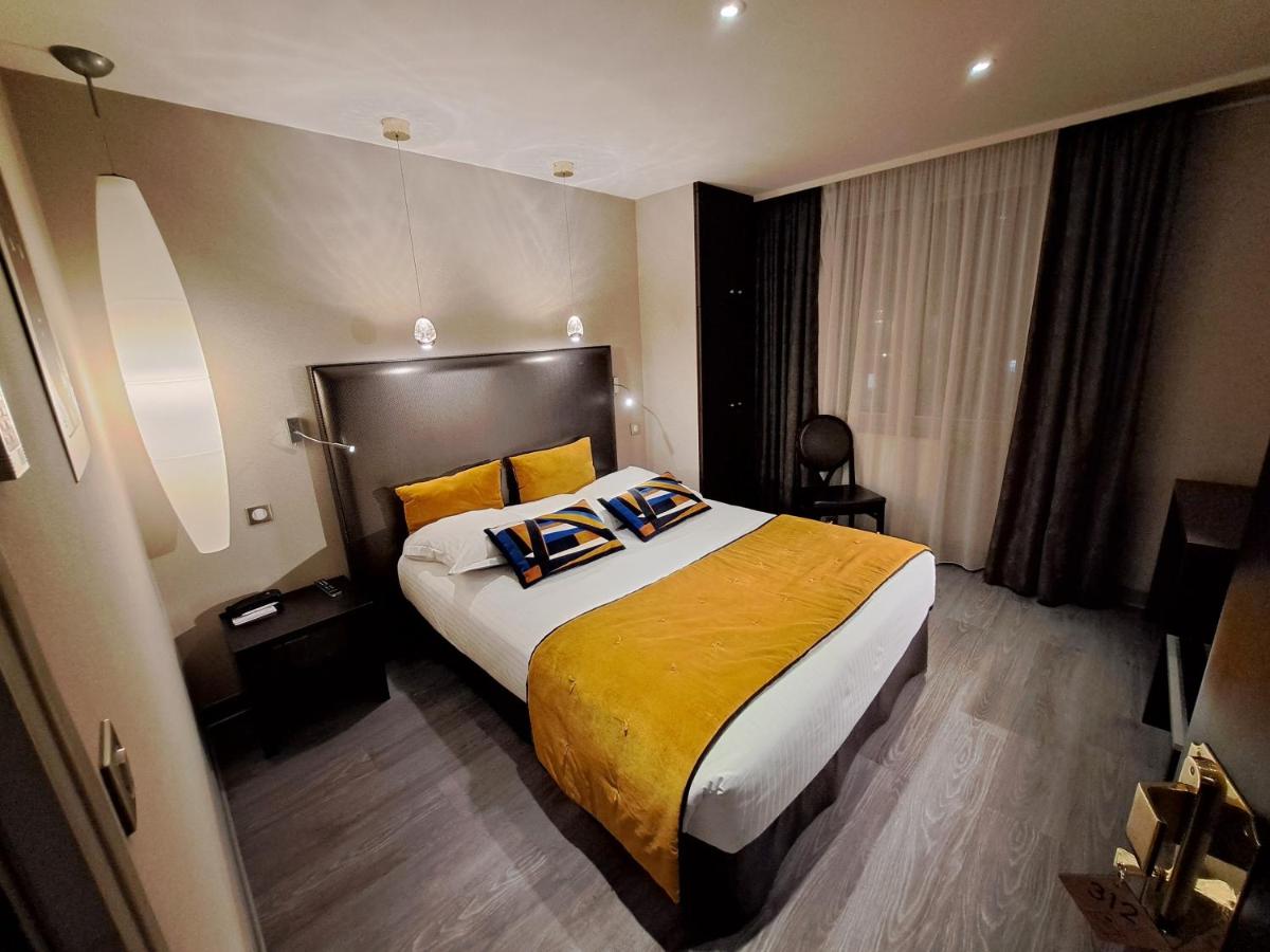 Un ou plusieurs lits dans un hébergement de l'établissement Hôtel des Princes, Chambéry Centre