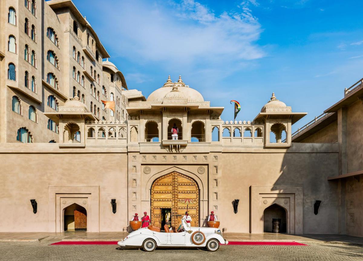 a white car parked in front of a building at Fairmont Jaipur in Jaipur