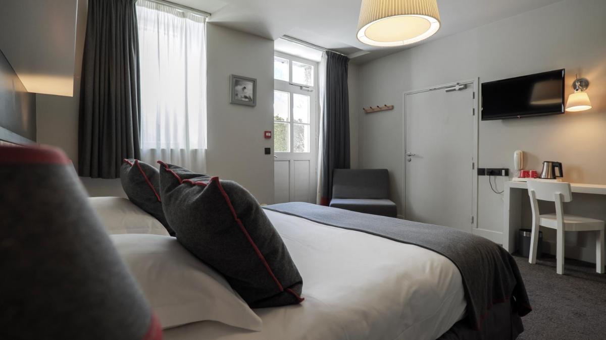 Un ou plusieurs lits dans un hébergement de l'établissement Le Faucigny - Hotel de Charme & SPA