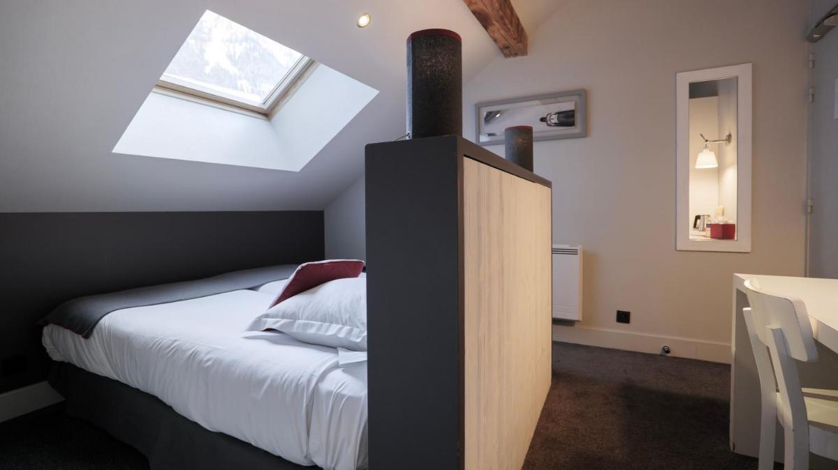 Un ou plusieurs lits dans un hébergement de l'établissement Le Faucigny - Hotel de Charme & SPA