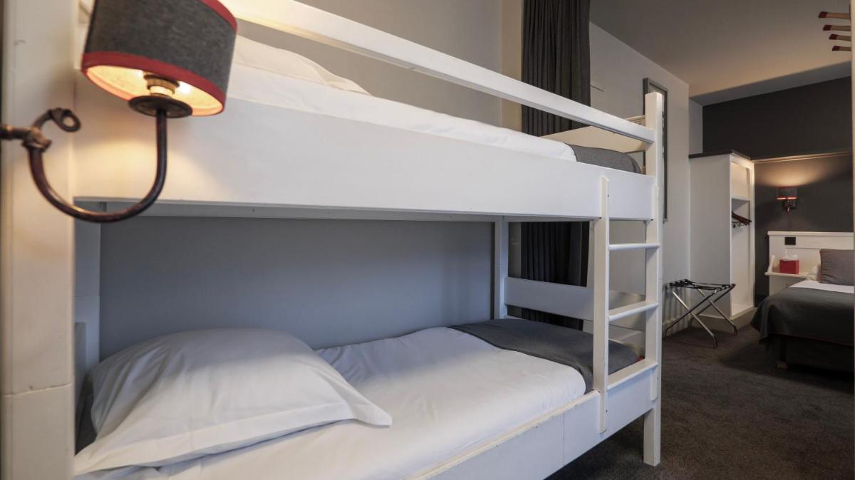 Un ou plusieurs lits dans un hébergement de l'établissement Le Faucigny - Hotel de Charme & SPA
