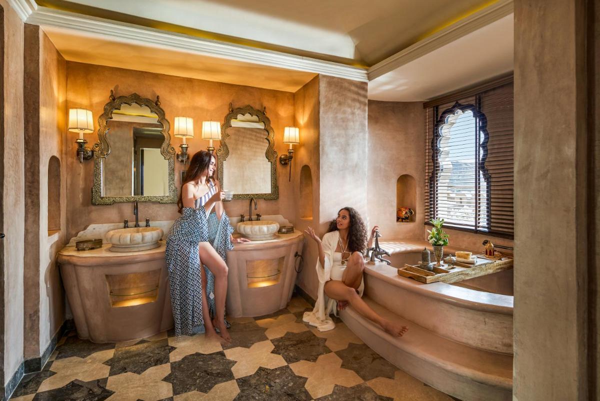 two women in a bathroom with two sinks at Fairmont Jaipur in Jaipur