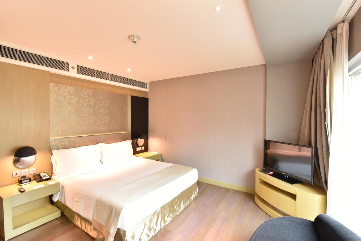 a hotel room with a bed and a flat screen tv at Holiday Inn New Delhi Aerocity by IHG in New Delhi