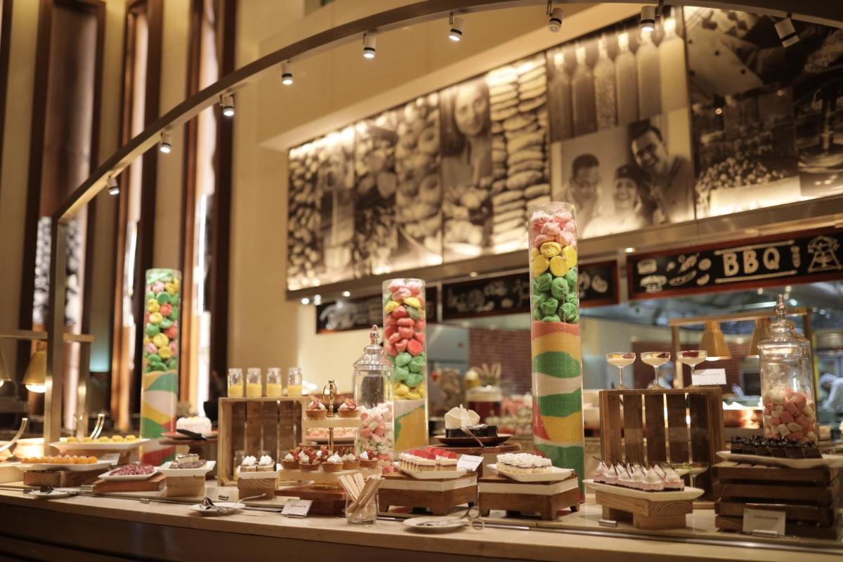 a bakery with many different types of cakes on display at Holiday Inn Mumbai International Airport by IHG in Mumbai