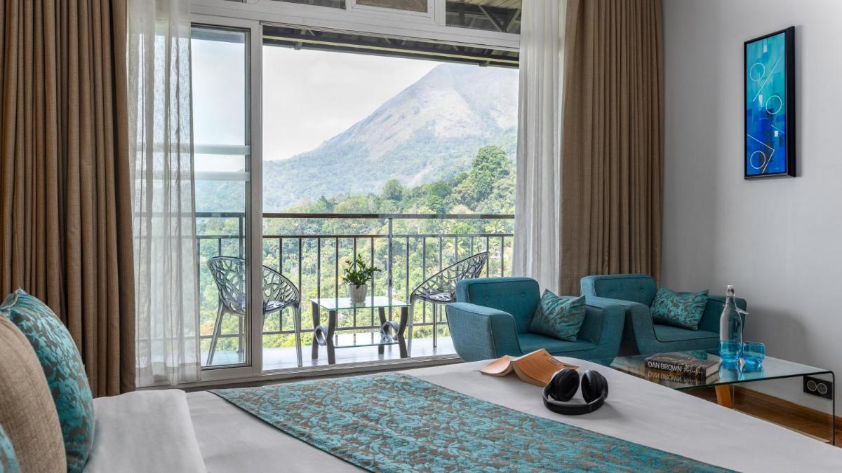 a hotel room with a view of a mountain at The Panoramic Getaway in Munnar