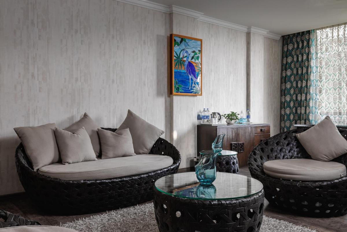 a living room with two couches and a table at The Panoramic Getaway in Munnar