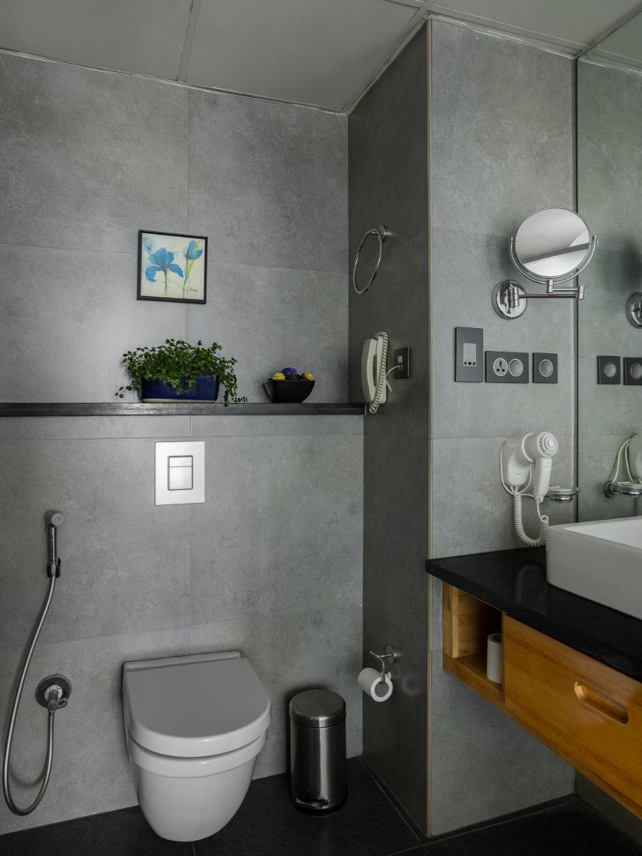 a bathroom with a toilet and a sink at The Panoramic Getaway in Munnar
