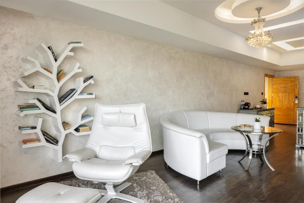 a living room with a white couch and a chair at The Panoramic Getaway in Munnar