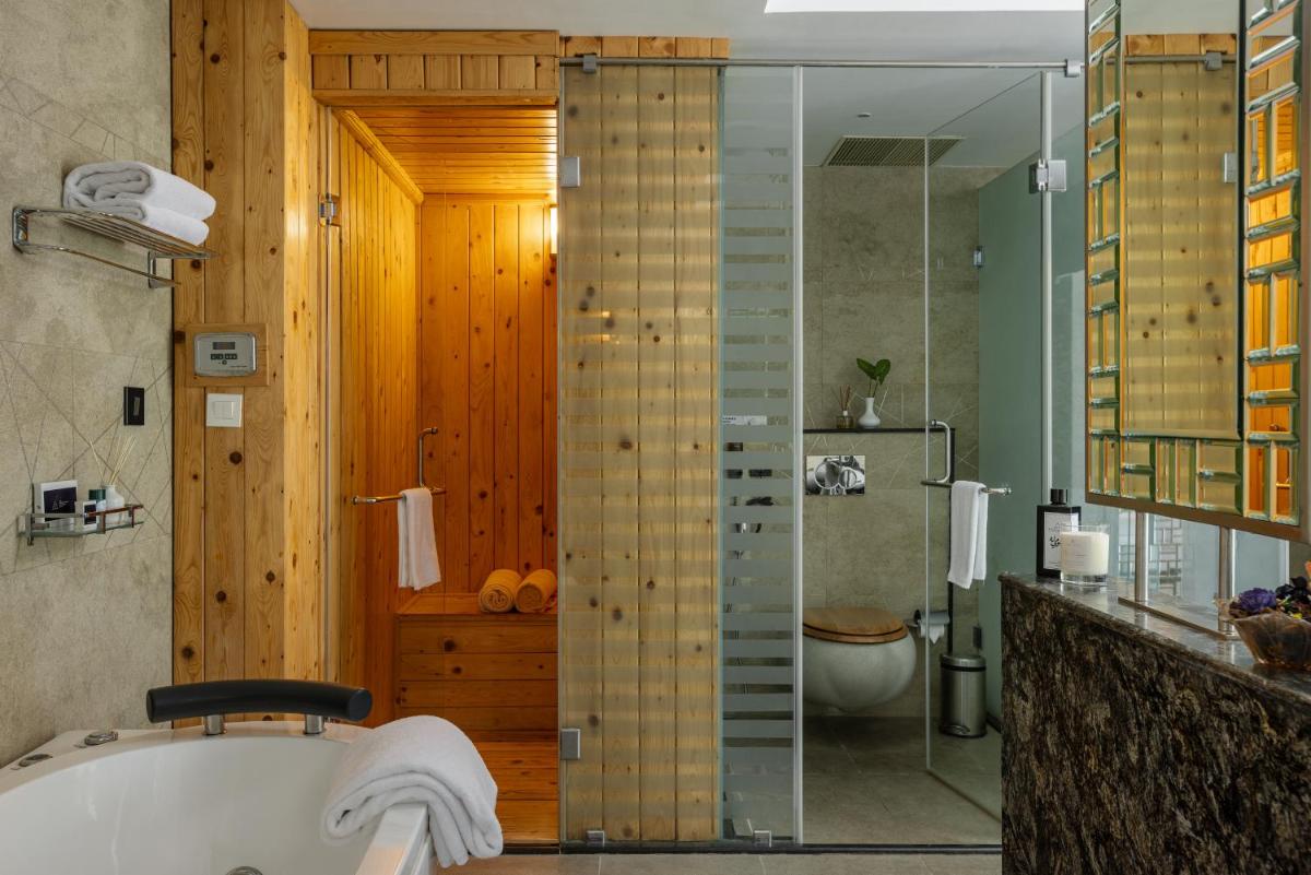 a bathroom with a tub and a toilet and a shower at The Panoramic Getaway in Munnar