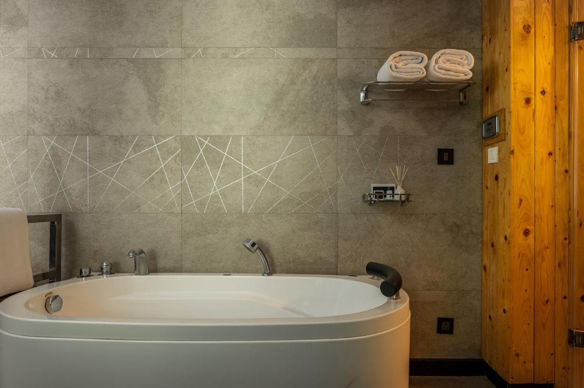 a bathroom with a bath tub in a room at The Panoramic Getaway in Munnar