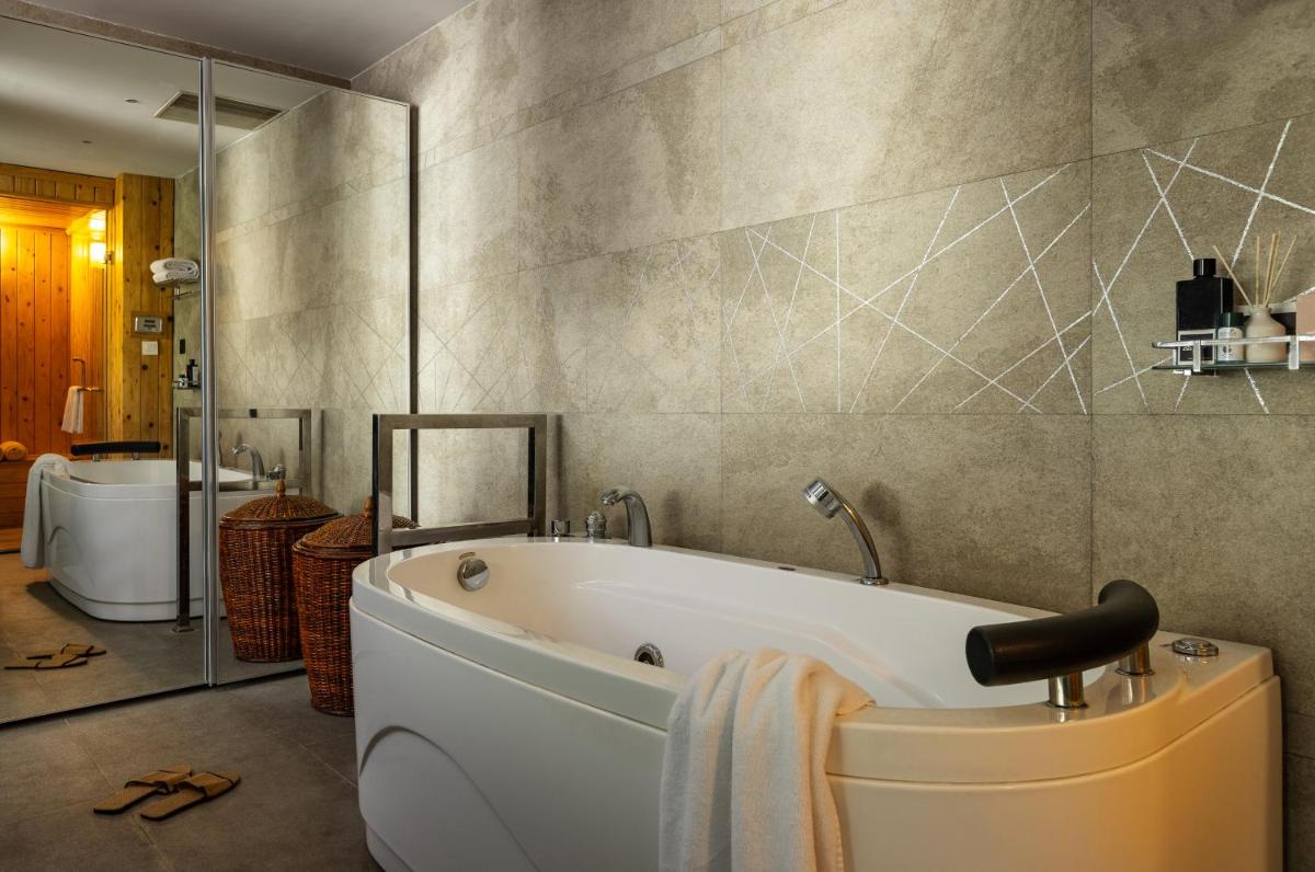 a bathroom with a bath tub and a toilet at The Panoramic Getaway in Munnar