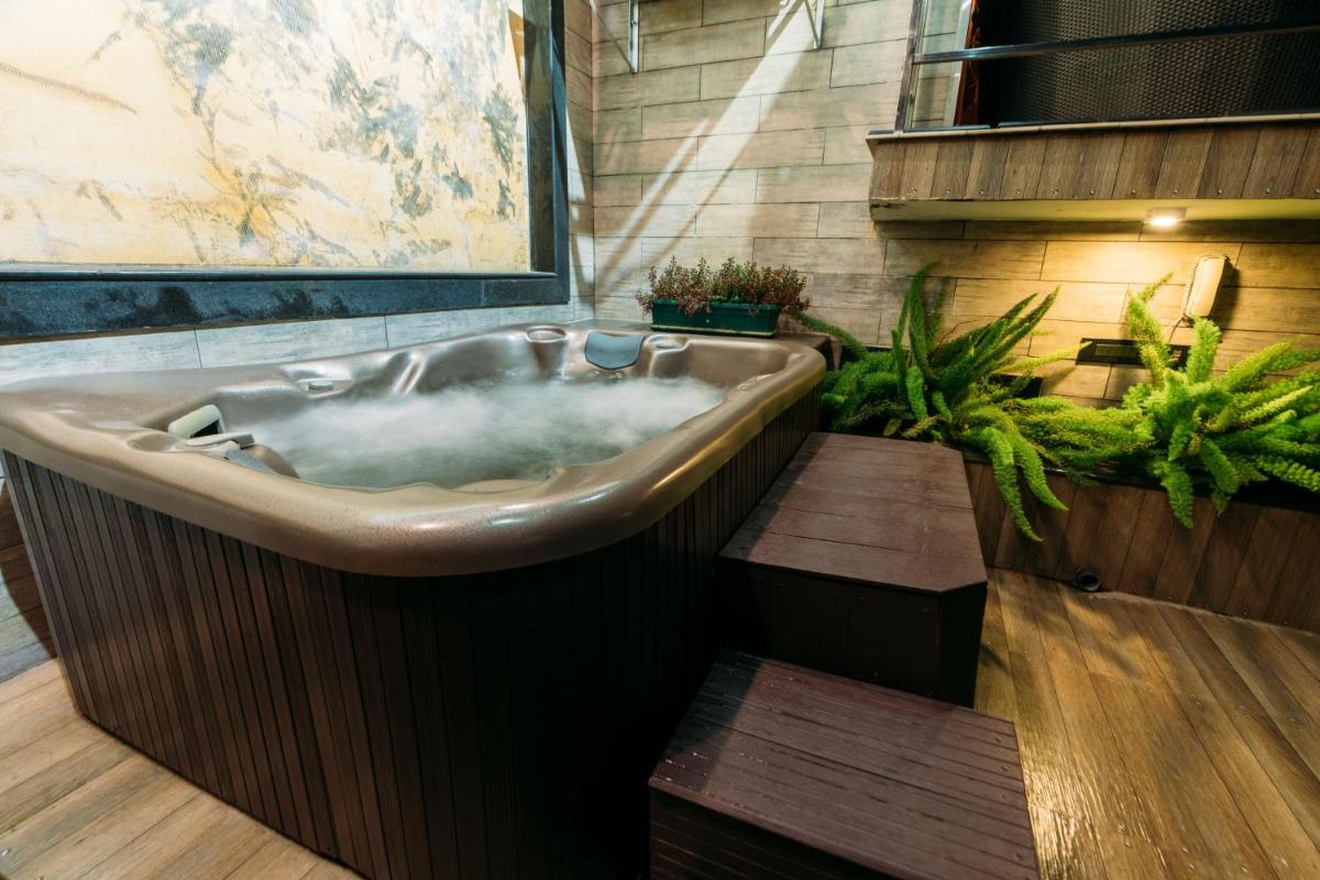 a bath tub filled with water in a bathroom at The Panoramic Getaway in Munnar