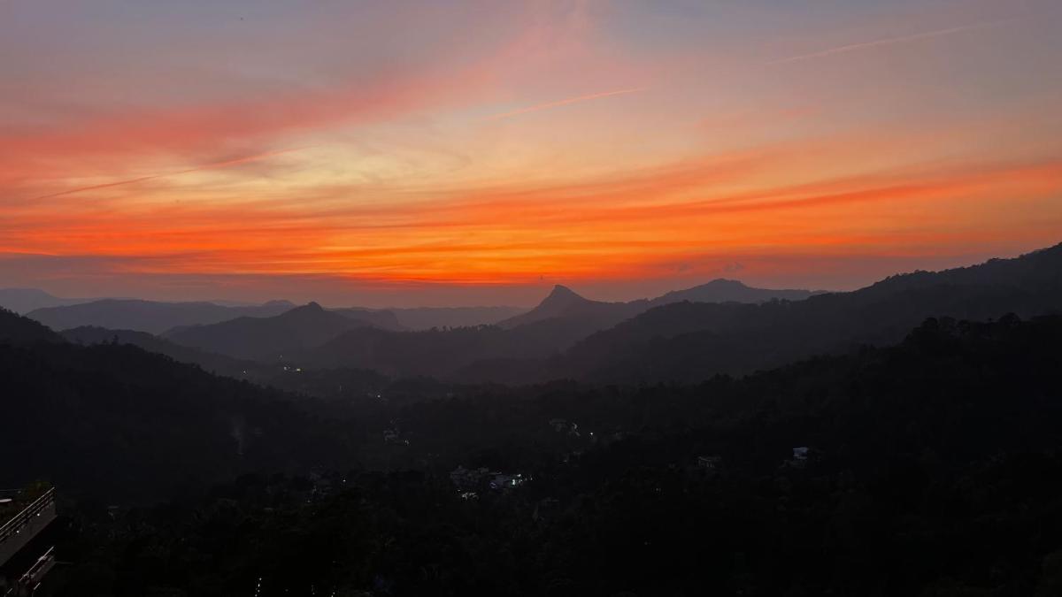 a sunset in the mountains with the sky at The Panoramic Getaway in Munnar