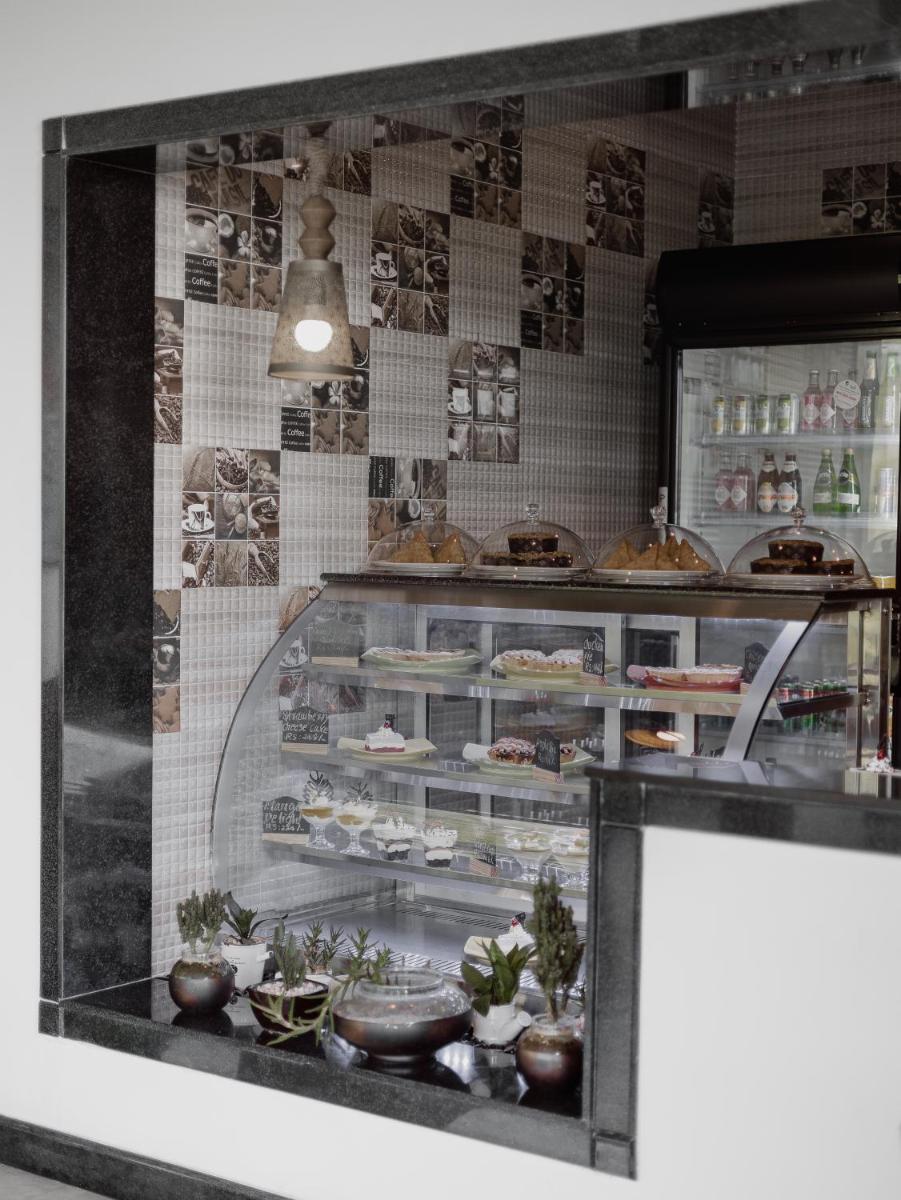 a display window of a bakery with food on display at The Panoramic Getaway in Munnar