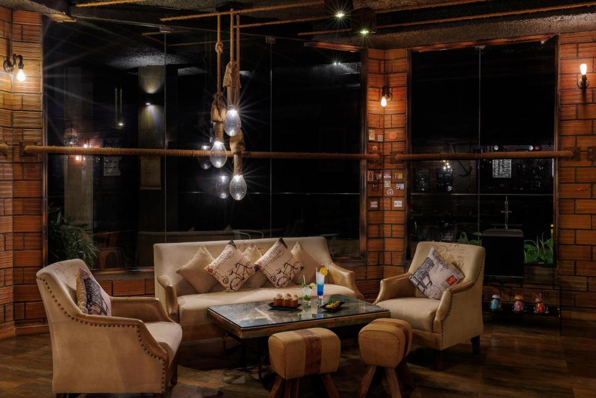 a living room with couches and a table at The Panoramic Getaway in Munnar
