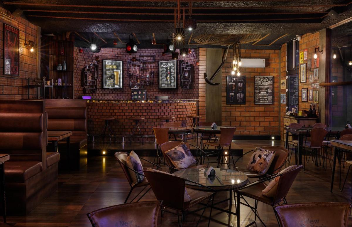 a restaurant with tables and chairs and a brick wall at The Panoramic Getaway in Munnar